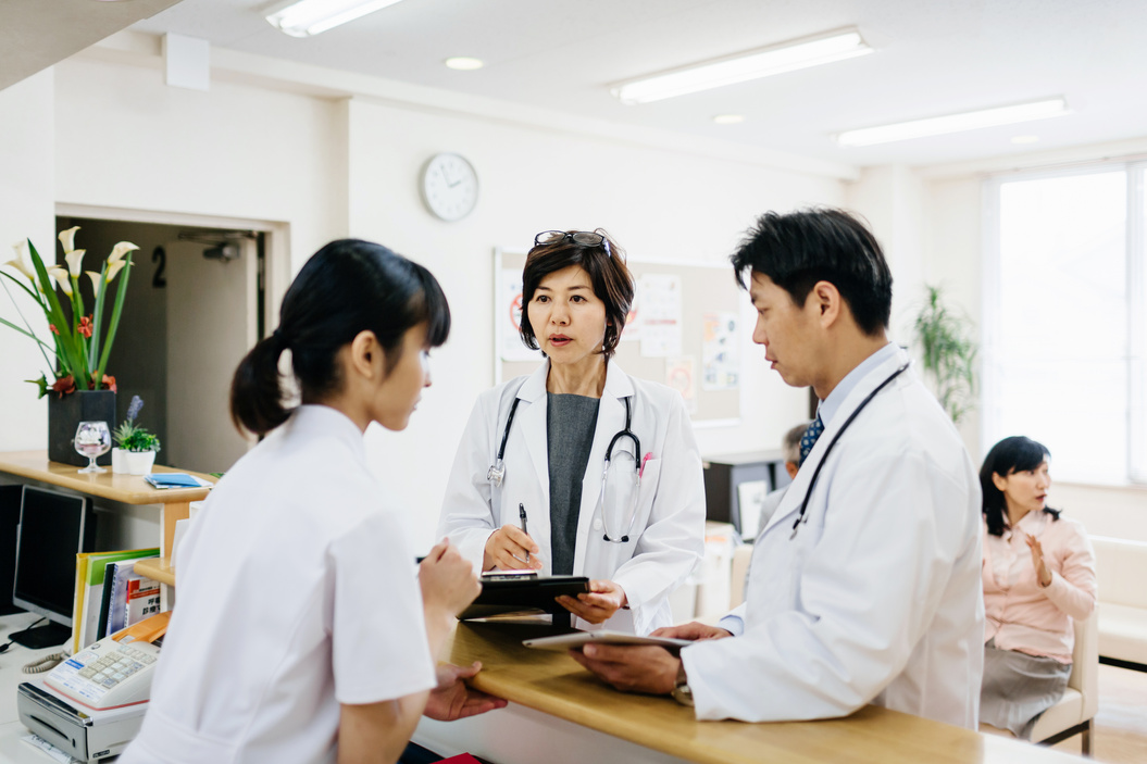 Japanese Doctors Talking At Hospital Reception